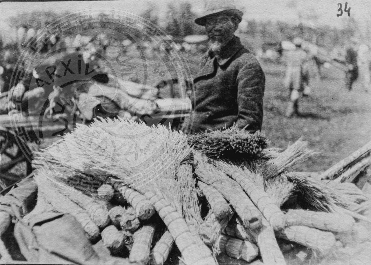 Photo 16. A Korean man sells brooms at a fair. 1920s-1930s.