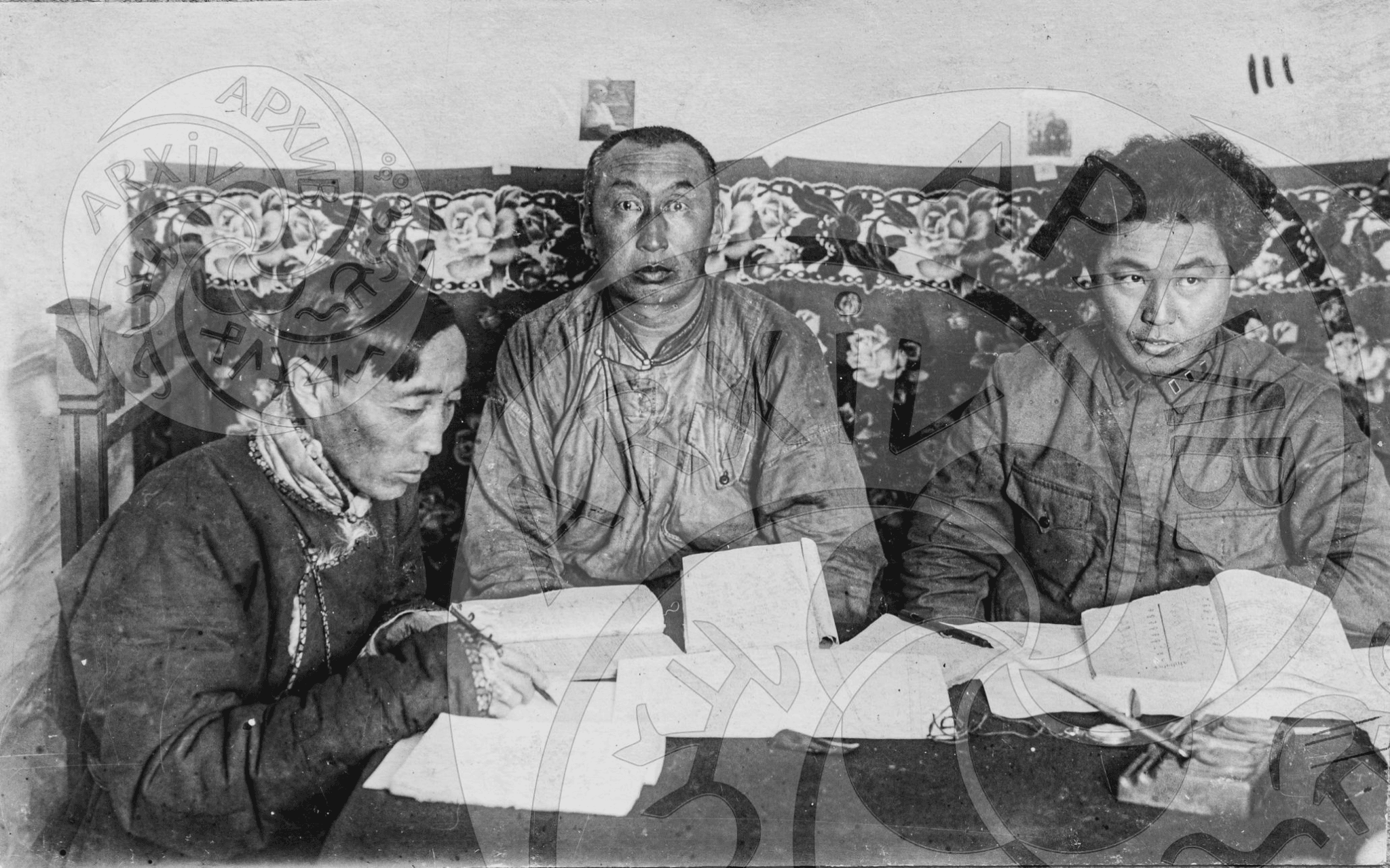 Photo 18. Donduk, Lopsan-Chimit, Natsov working on the creation of an alphabet for the Tuvan script. Donduk's apartment. 1920s